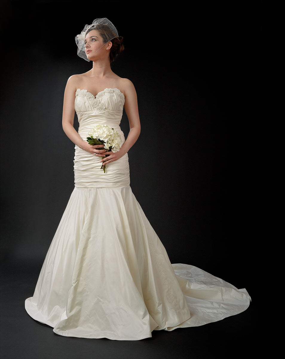 anna nieman designer wedding dress Boston. A Classic mermaid gown from silk/taffeta with ruched bodice and an appliquéd neck-line
